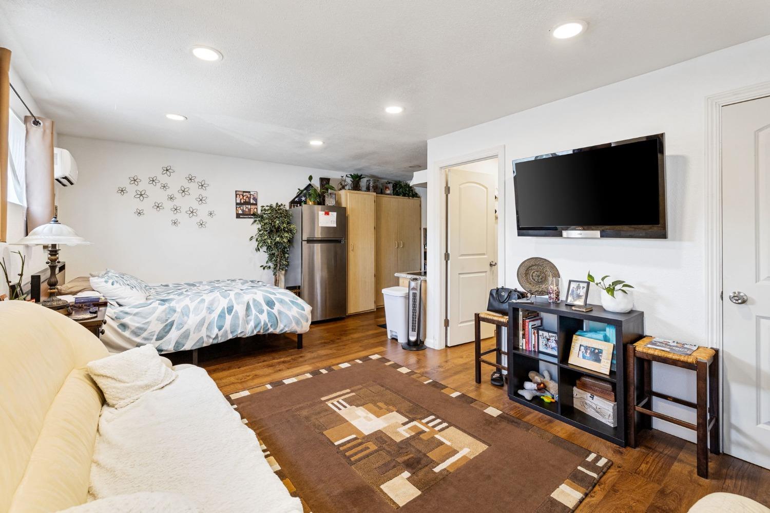 1345 Peach Avenue Clovis, CA 93612 - Photo 20 of 27 a bedroom with furniture and a flat screen tv