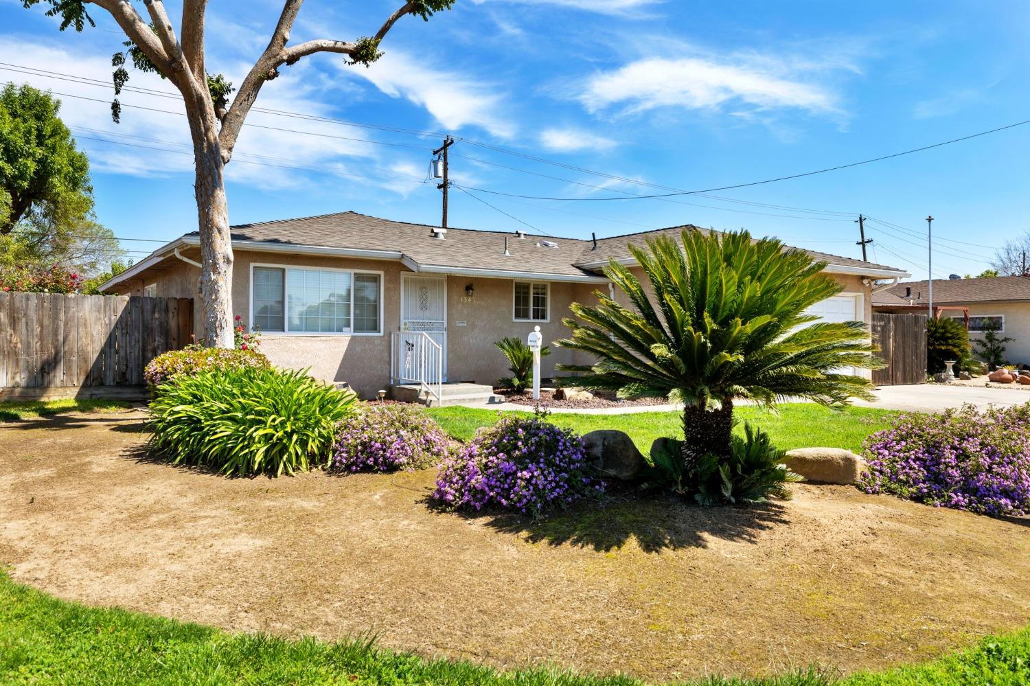 1345 Peach Avenue Clovis, CA 93612 - Photo 2 of 27 a front view of a house with garden