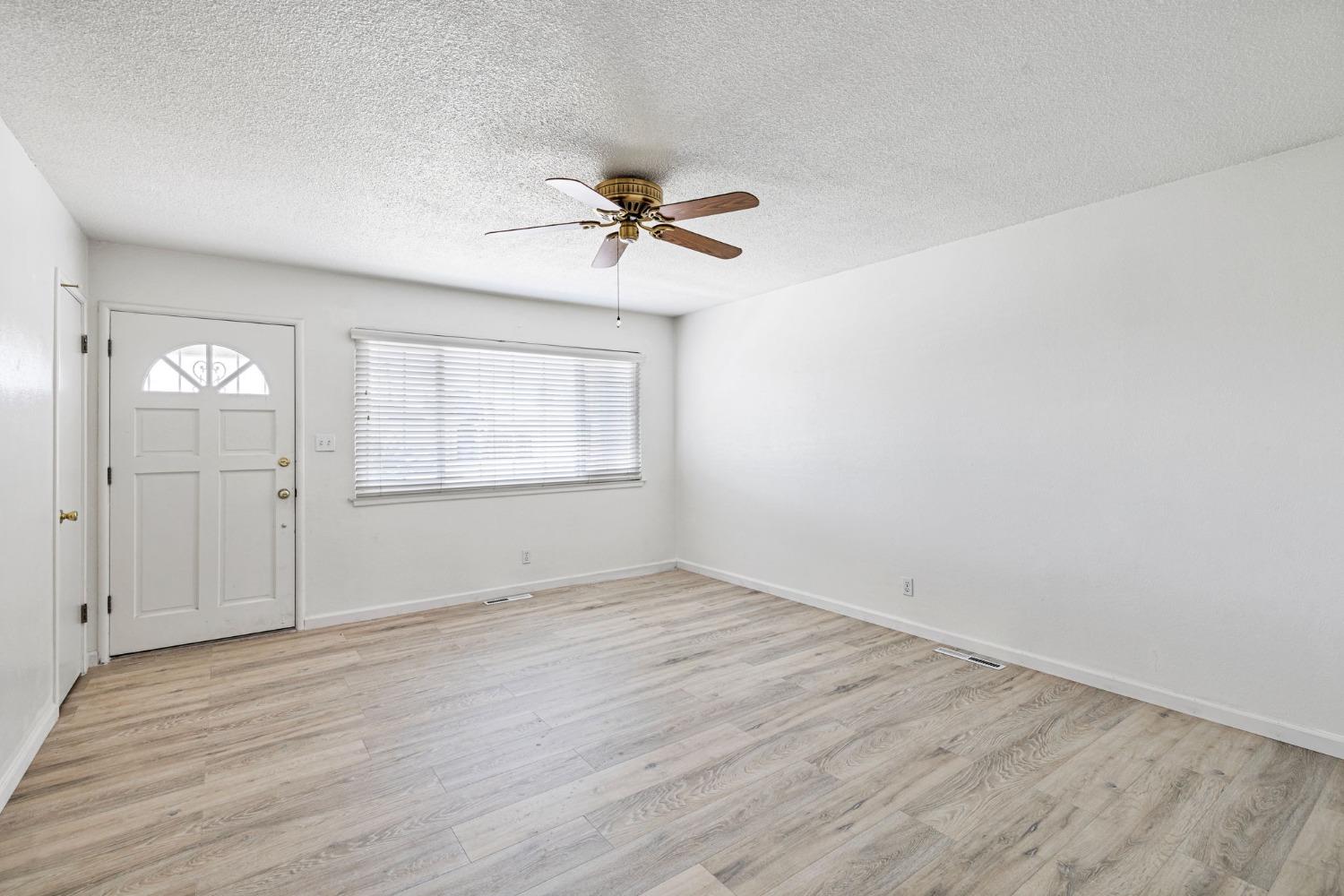 1345 Peach Avenue Clovis, CA 93612 - Photo 5 of 27 wooden floor in an empty room with a window