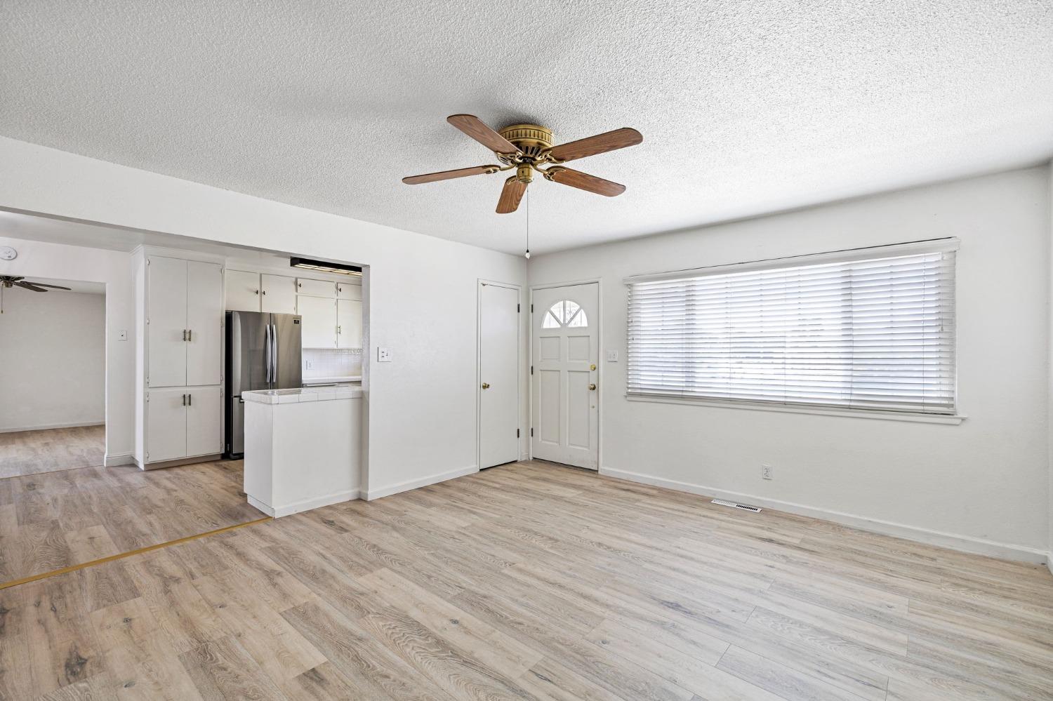 1345 Peach Avenue Clovis, CA 93612 - Photo 6 of 27 a view of empty room with wooden floor and ceiling fan