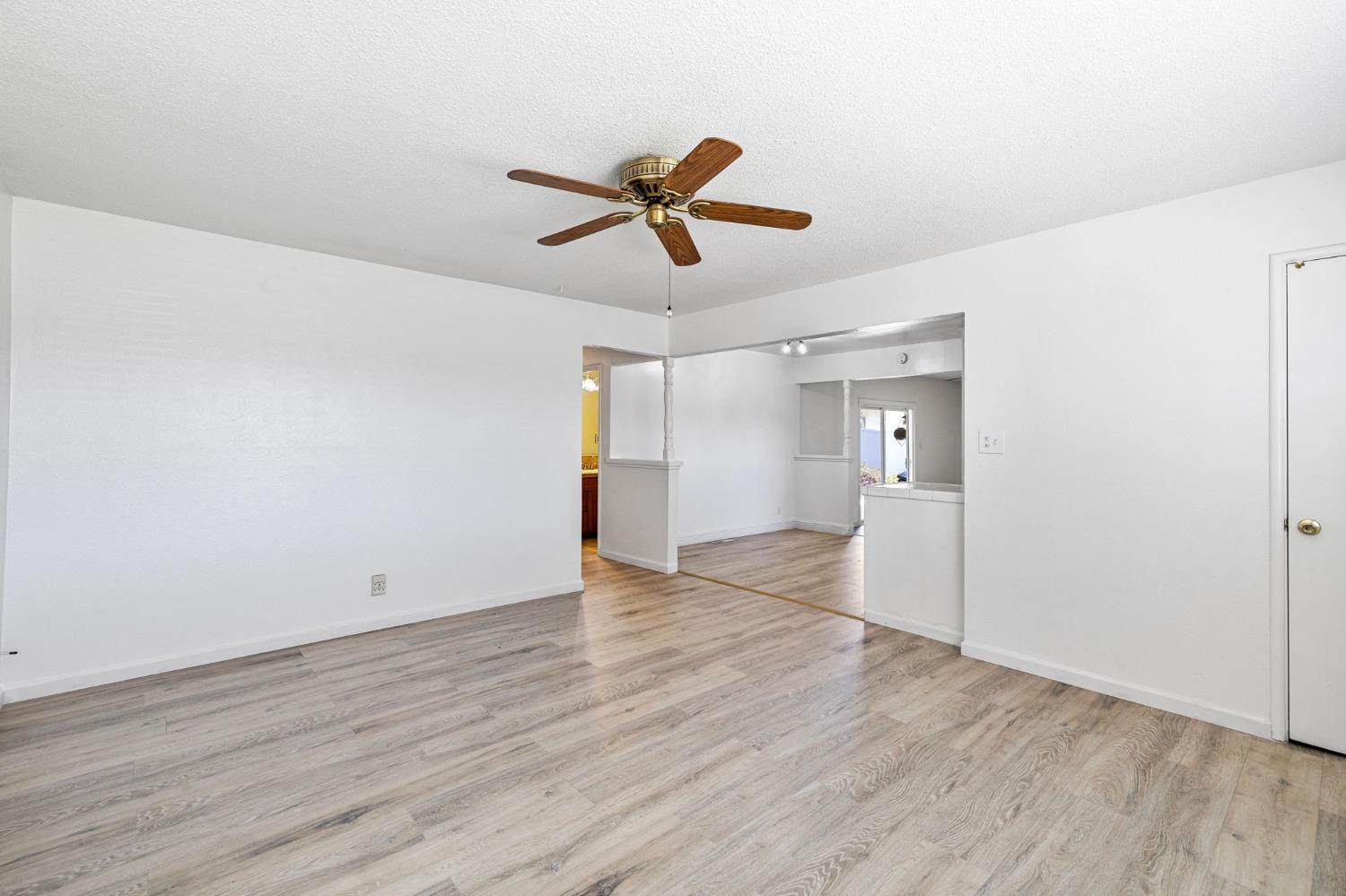 1345 Peach Avenue Clovis, CA 93612 - Photo 7 of 27 a view of empty room with wooden floor and ceiling fan