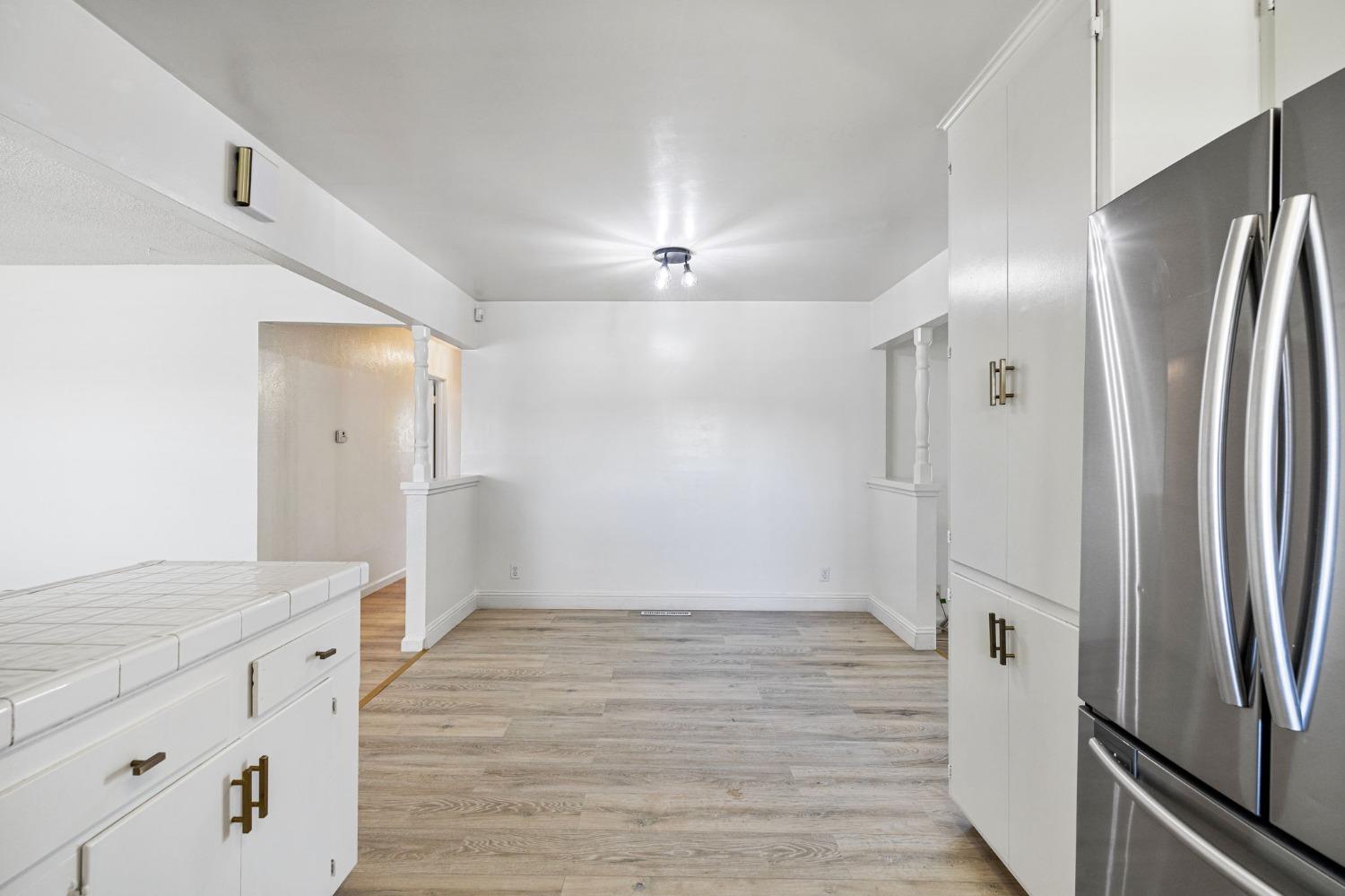 1345 Peach Avenue Clovis, CA 93612 - Photo 9 of 27 a kitchen with stainless steel appliances granite countertop a refrigerator and a sink
