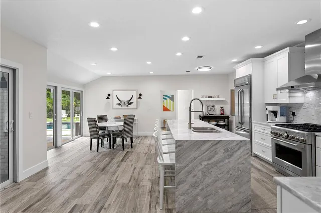 a large kitchen with stainless steel appliances lots of counter space and a refrigerator