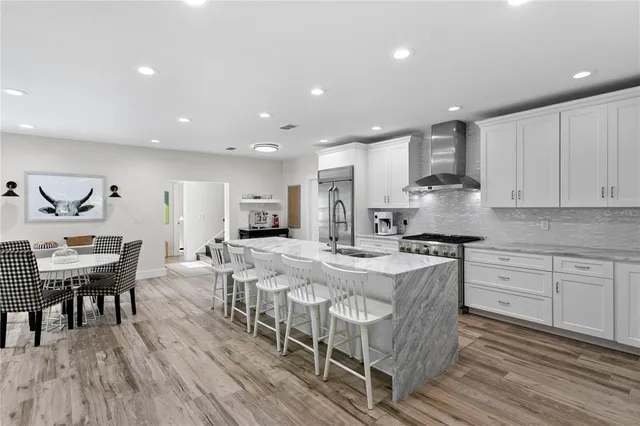 a kitchen with white cabinets and white appliances
