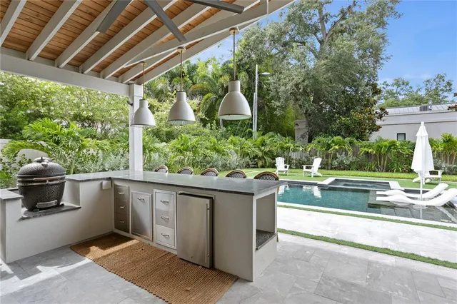 a view of a house with swimming pool and sitting area