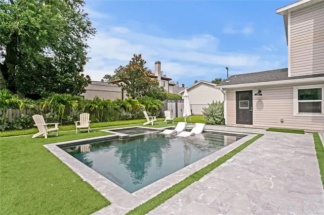 a bathroom with a granite countertop sink mirror and bathtub