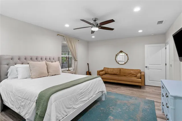 a bathroom with a granite countertop sink a large mirror a toilet and a