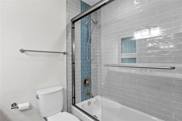 a bathroom with a bathtub and shower