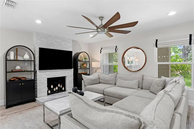 a living room with furniture a clock and a fireplace