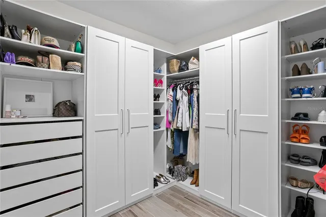 an aerial view of residential houses with outdoor space and parking