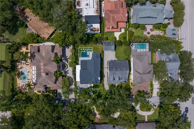 a front view of a house with a yard and potted plants