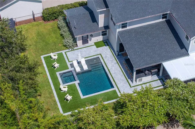 a view of a house with swimming pool and sitting area