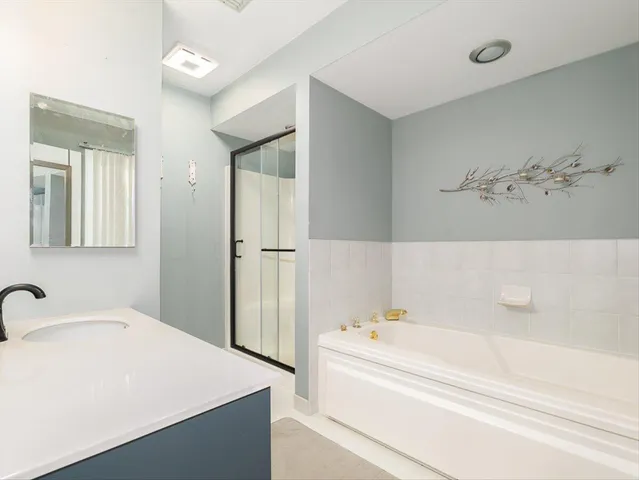 a bathroom with a tub and a sink