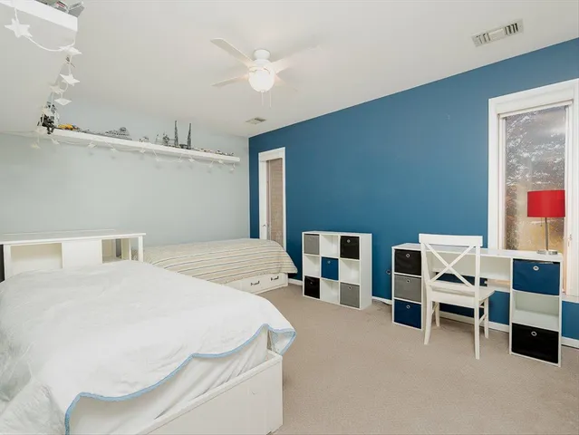 a bedroom with a bed and a workspace