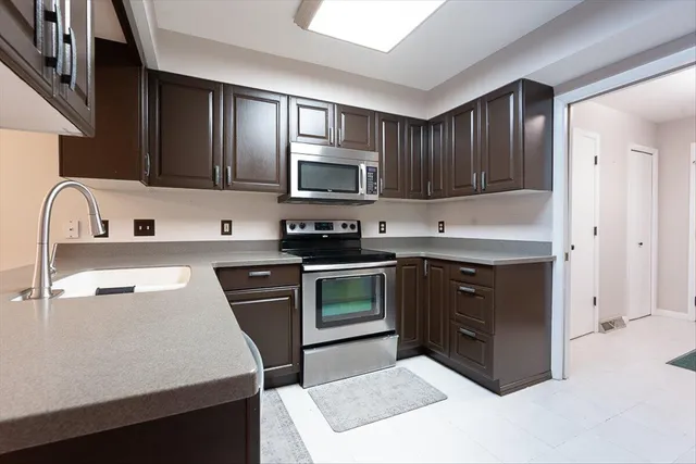 a kitchen with a sink stove and microwave