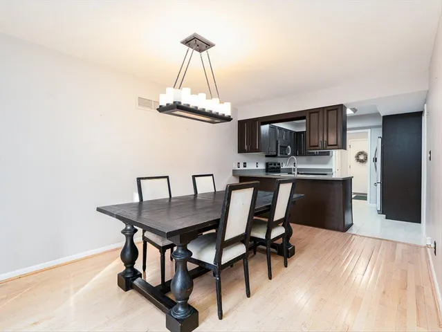 a dining room with a table chairs and a kitchen view