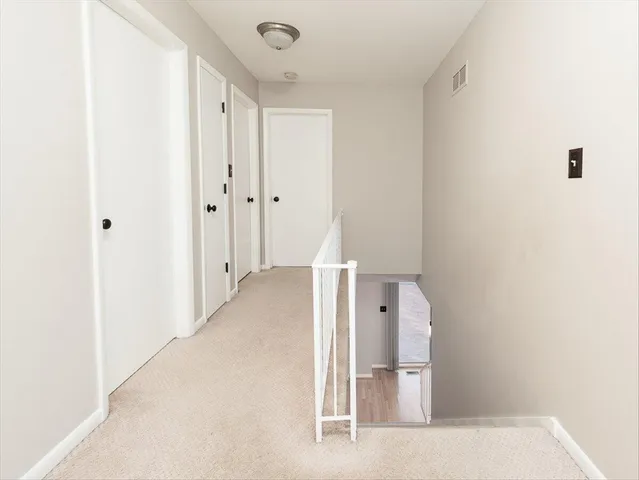 a view of a hallway to an empty room