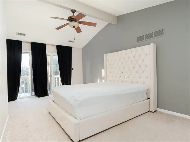 a large white bed in a white room