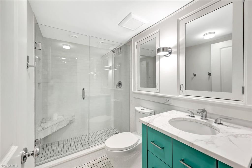4451 Gulf Shore Boulevard North, Unit 506 Naples, FL 34103 - Photo 16 of 32 a bathroom with a sink a toilet and shower