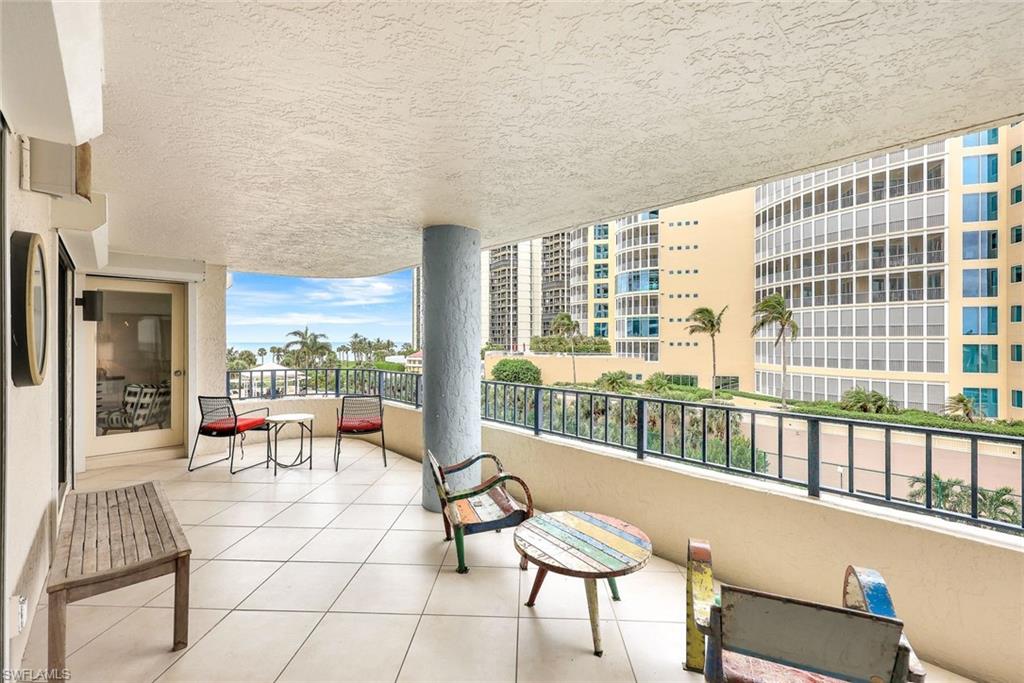 4451 Gulf Shore Boulevard North, Unit 506 Naples, FL 34103 - Photo 20 of 32 a living room with furniture and a large window