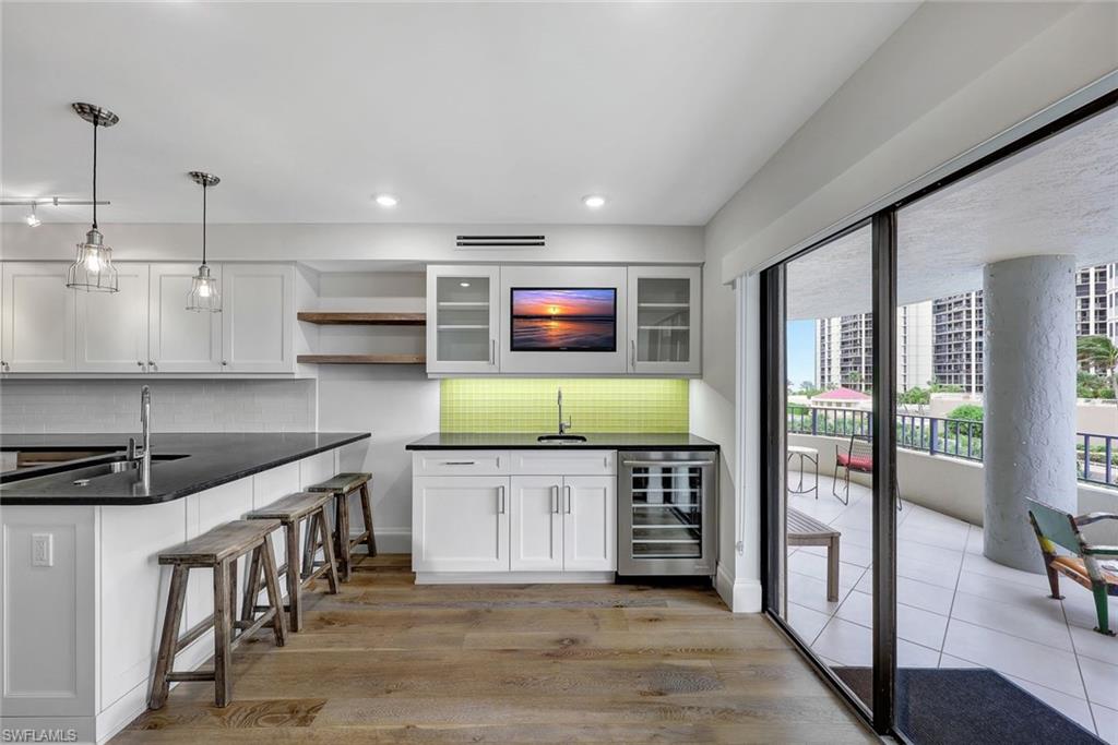 4451 Gulf Shore Boulevard North, Unit 506 Naples, FL 34103 - Photo 8 of 32 a kitchen with stainless steel appliances granite countertop a stove a sink and a refrigerator