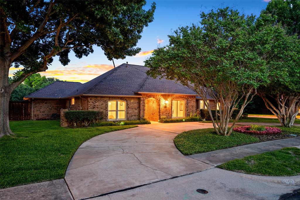 400 Hunters Ridge Circle Coppell, TX 75019 - Photo 25 of 35 a front view of a house with garden