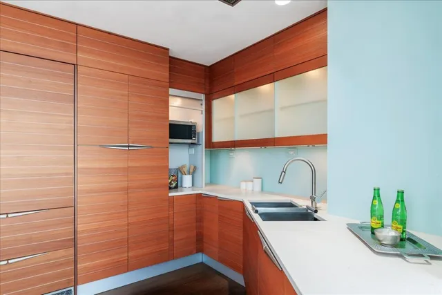 a kitchen with stainless steel appliances a sink and cabinets