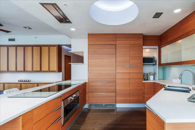 a kitchen with stainless steel appliances granite countertop a sink and a stove