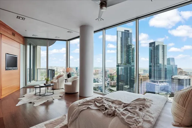 a bedroom with furniture and large windows