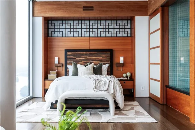 a bed sitting in a bedroom next to a window