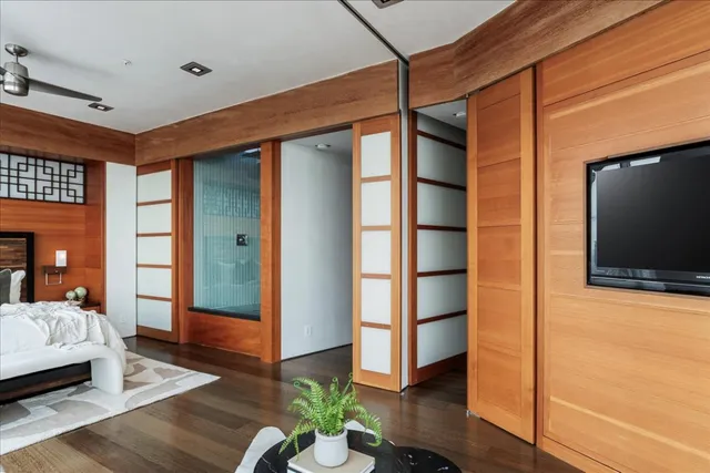 a bedroom with furniture and wooden floor