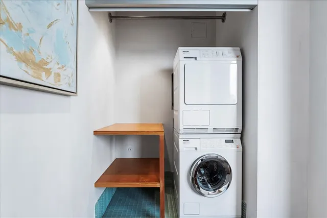 a bathroom with a granite countertop sink a toilet a mirror and shower