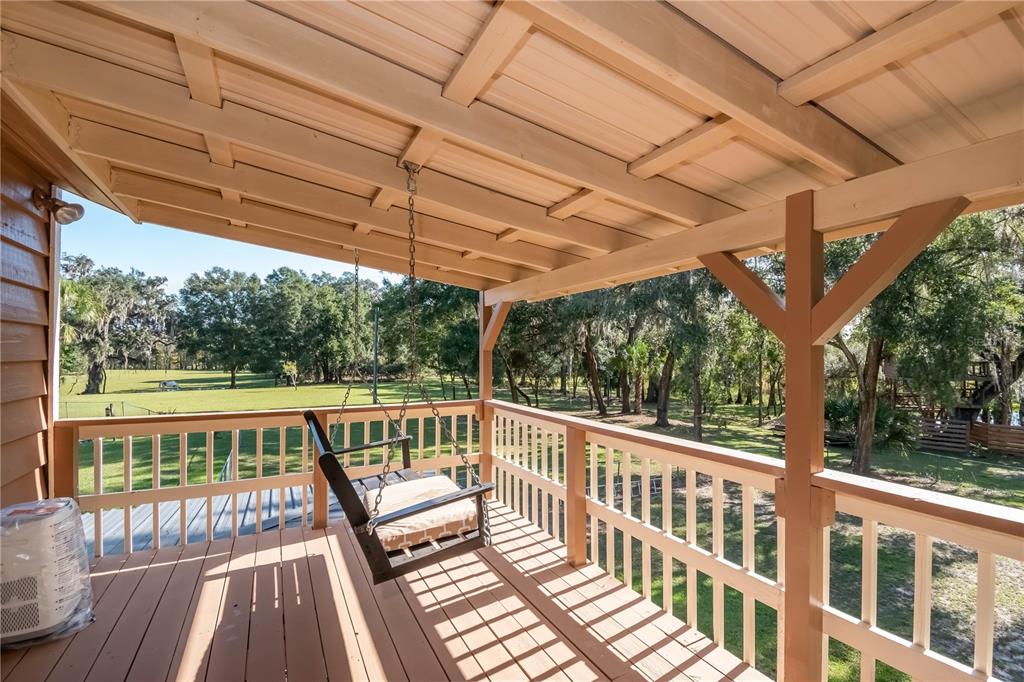 15615 Northeast 21st Avenue Road Citra, FL 32113 - Photo 20 of 98 a view of a porch with wooden floor in front of a house