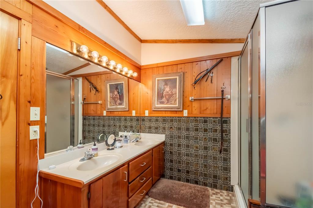 15615 Northeast 21st Avenue Road Citra, FL 32113 - Photo 22 of 98 a bathroom with a sink mirror and a shower