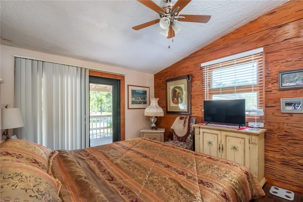 15615 Northeast 21st Avenue Road Citra, FL 32113 - Photo 23 of 98 a bedroom with a bed and a flat screen tv