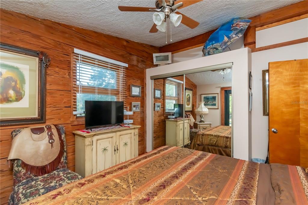 15615 Northeast 21st Avenue Road Citra, FL 32113 - Photo 24 of 98 a bedroom with a bed and wooden floor