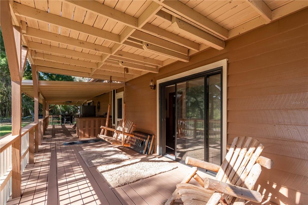 15615 Northeast 21st Avenue Road Citra, FL 32113 - Photo 30 of 98 a view of a patio with table and chairs and wooden floor