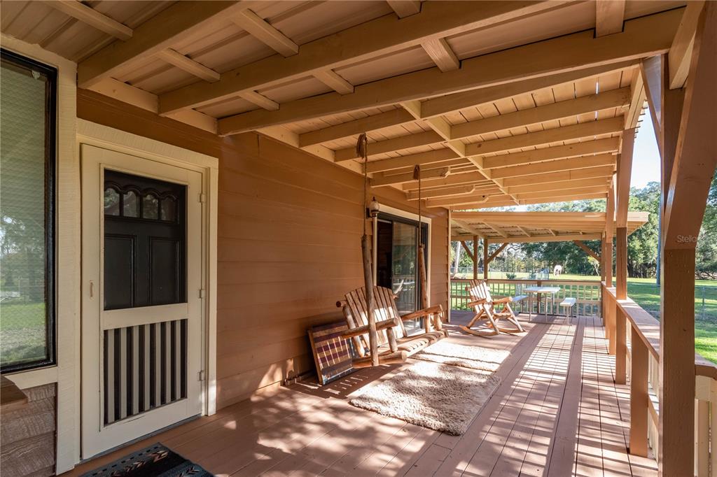 15615 Northeast 21st Avenue Road Citra, FL 32113 - Photo 31 of 98 a view of a porch with furniture and floor to ceiling window