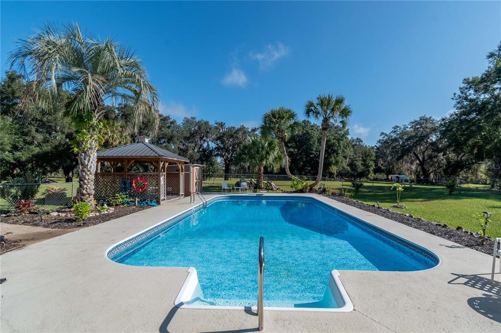 15615 Northeast 21st Avenue Road Citra, FL 32113 - Photo 34 of 98 a view of a swimming pool with a patio
