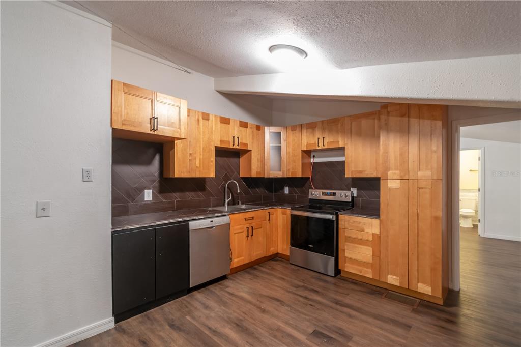 15615 Northeast 21st Avenue Road Citra, FL 32113 - Photo 61 of 98 a kitchen with stainless steel appliances granite countertop a sink and stove