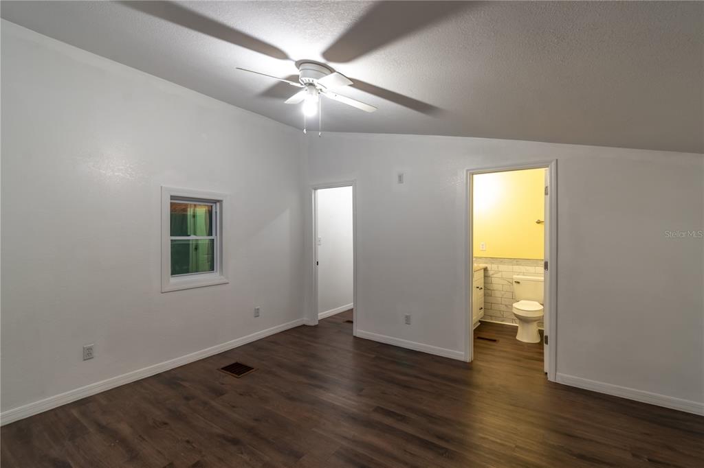 15615 Northeast 21st Avenue Road Citra, FL 32113 - Photo 62 of 98 an empty room with wooden floor and windows