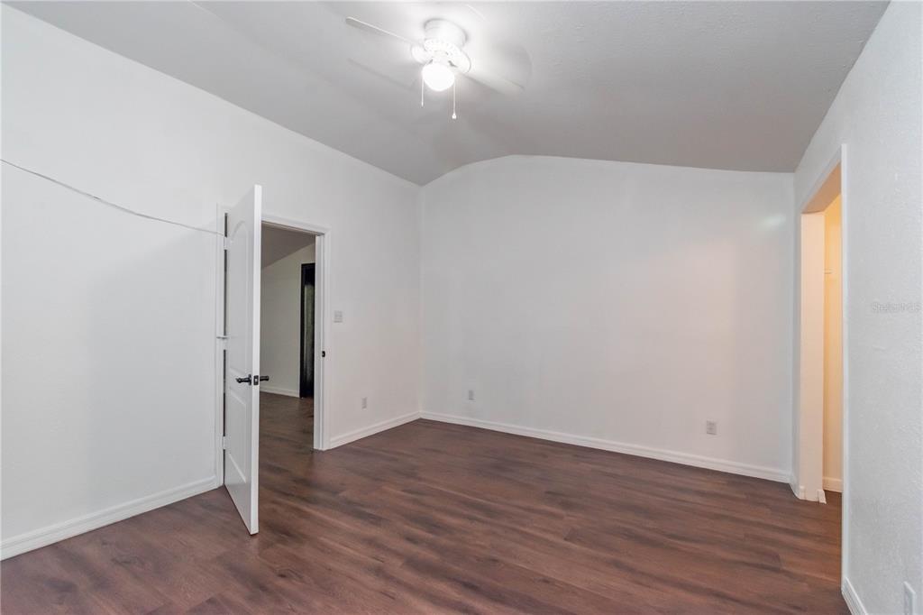 15615 Northeast 21st Avenue Road Citra, FL 32113 - Photo 70 of 98 an empty room with wooden floor and windows