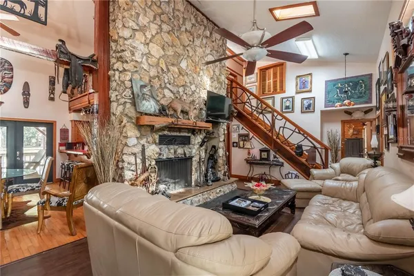 a bathroom with a granite countertop sink a mirror and shower