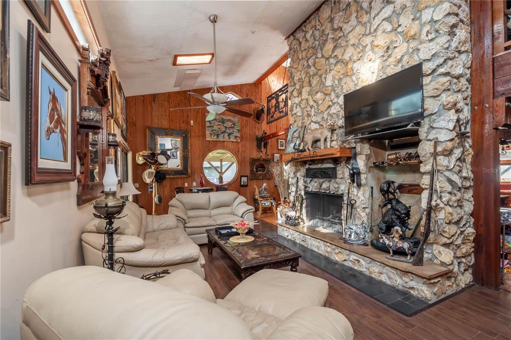 15615 Northeast 21st Avenue Road Citra, FL 32113 - Photo 9 of 98 a living room with furniture a flat screen tv and a fireplace