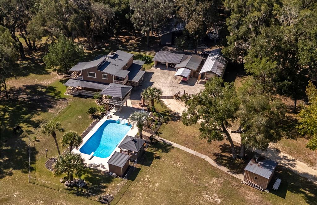 15615 Northeast 21st Avenue Road Citra, FL 32113 - Photo 91 of 98 an aerial view of a house with a yard and lake view