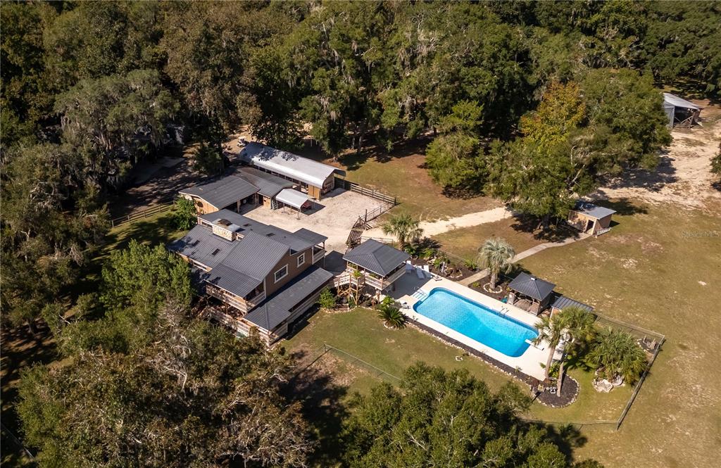15615 Northeast 21st Avenue Road Citra, FL 32113 - Photo 92 of 98 an aerial view of a house with a yard and trees