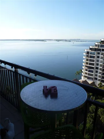 a view of a balcony with a table and chairs