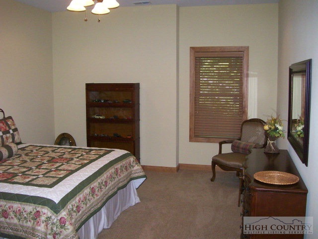 186 Harper Trail Boone, NC 28607 - Photo 28 of 46 a bedroom with a bed and a dresser