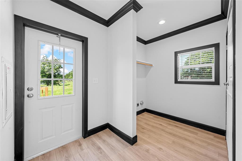 202 6th Street Mount Calm, TX 76673 - Photo 15 of 23 an empty room with wooden floor and windows
