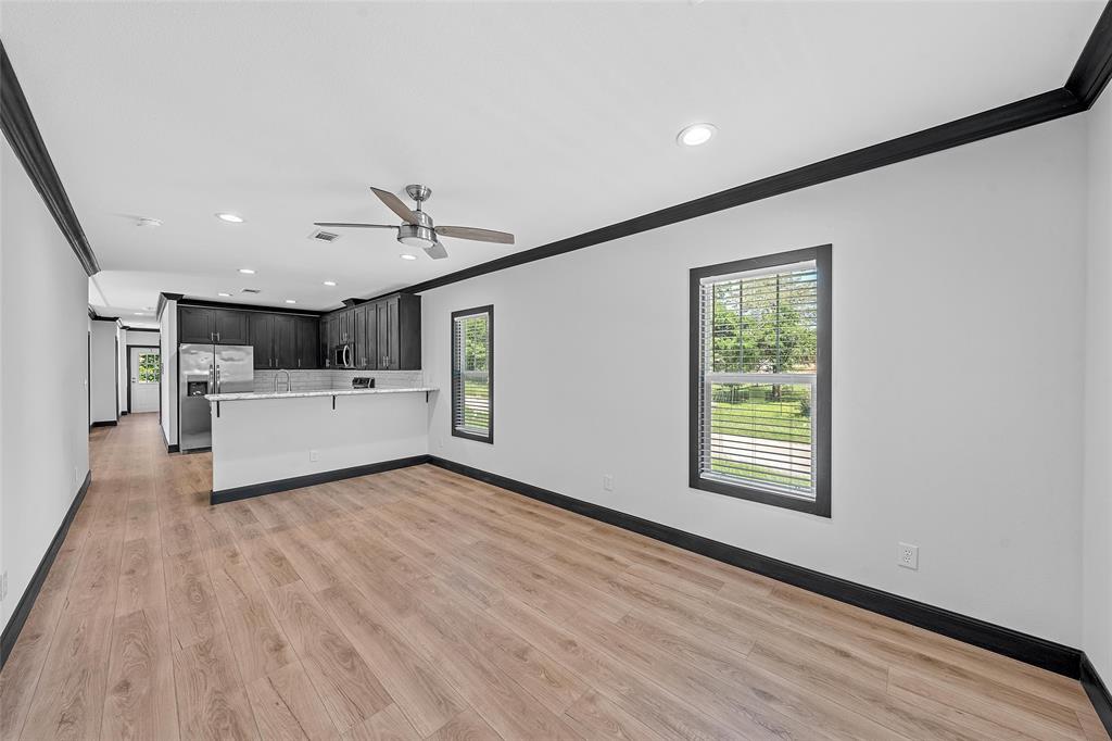 202 6th Street Mount Calm, TX 76673 - Photo 3 of 23 a view of a livingroom with a hardwood floor and a ceiling fan
